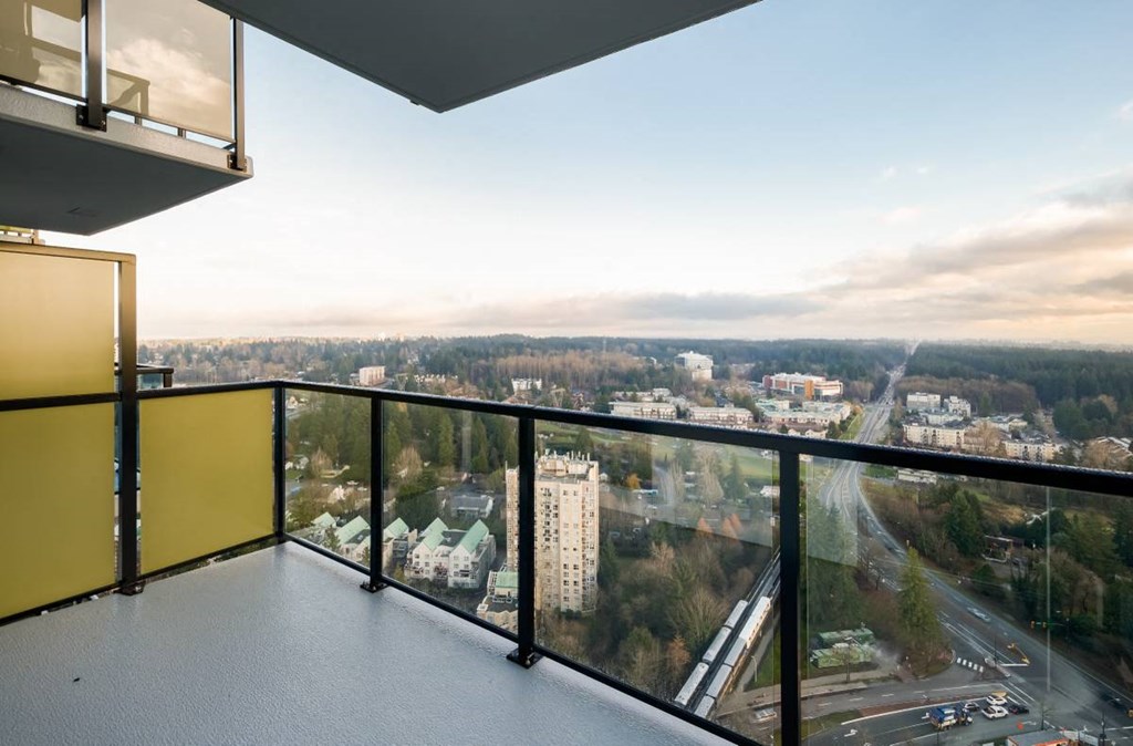 a balcony with a view of a city and a clear sky