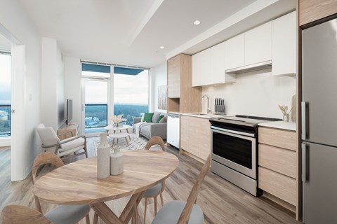 an open kitchen and living room with a table and chairs