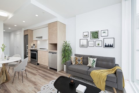 a living room with a couch and a table and a kitchen