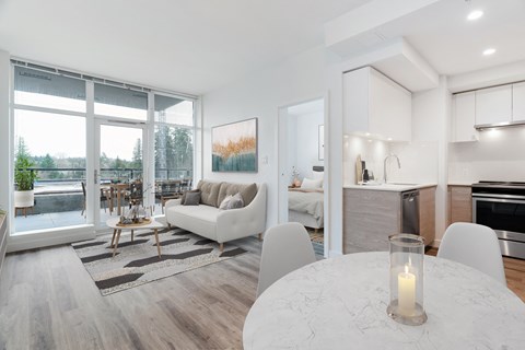 a living room and dining room with a couch and a table