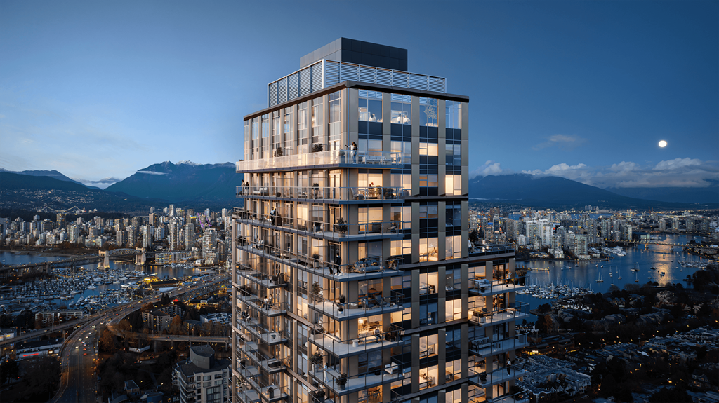 A tall, modern building with many windows is lit up at night.