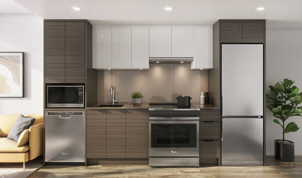 a modern kitchen with stainless steel appliances and white cabinets