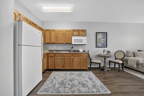 A kitchen with wooden cabinets and a white refrigerator.