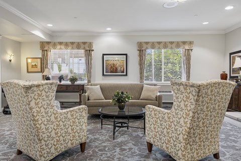 A living room with two chairs and a sofa.