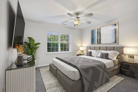 A bedroom with a large bed and a ceiling fan.