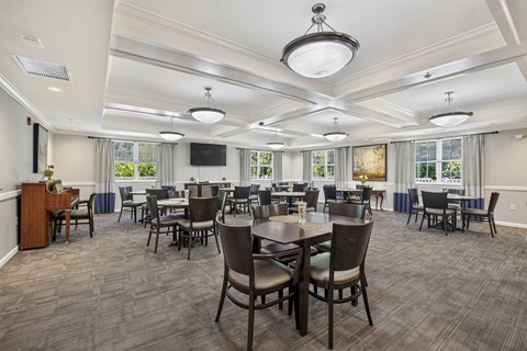 Community dining room with multiple tables and seating at Glenmont Abbey Village Apartments, New York, 12077