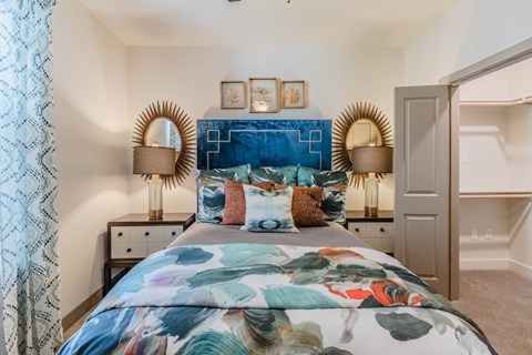 A bedroom with a large bed and a blue headboard.