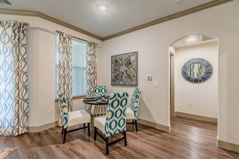 A dining room with a table and chairs. at Atlas Point at Prestonwood Apartments , Carrollton