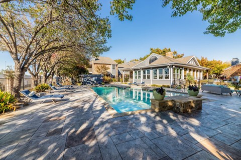 A house with a pool surrounded by trees. at Avalon Villas Apartments , Texas
