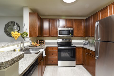 A kitchen with wooden cabinets and stainless steel appliances.