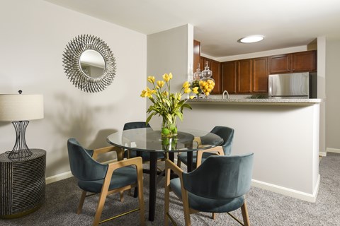 Open concept dining area with glass table at Chestnut Oaks Apartments, Fort Washington, MD