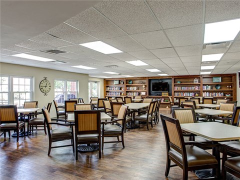 a dining room with tables and chairs in a library