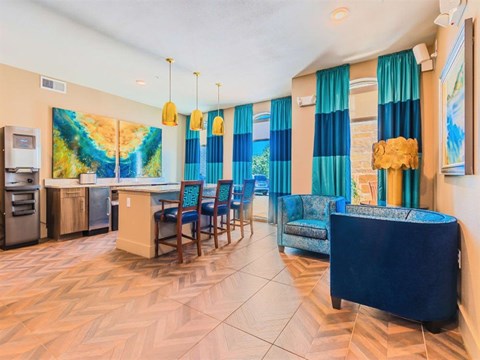 A kitchen with a blue table and chairs.