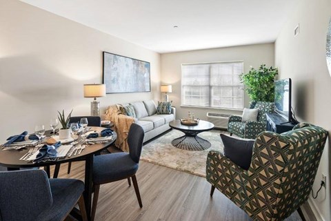 A modern dining room with a round table set for a meal.