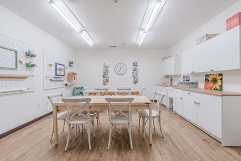 A kitchen with a table and chairs in the middle of the room.