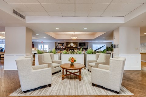 A living room with a coffee table and chairs.