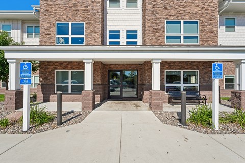 A building with a brick facade and a glass door entrance.