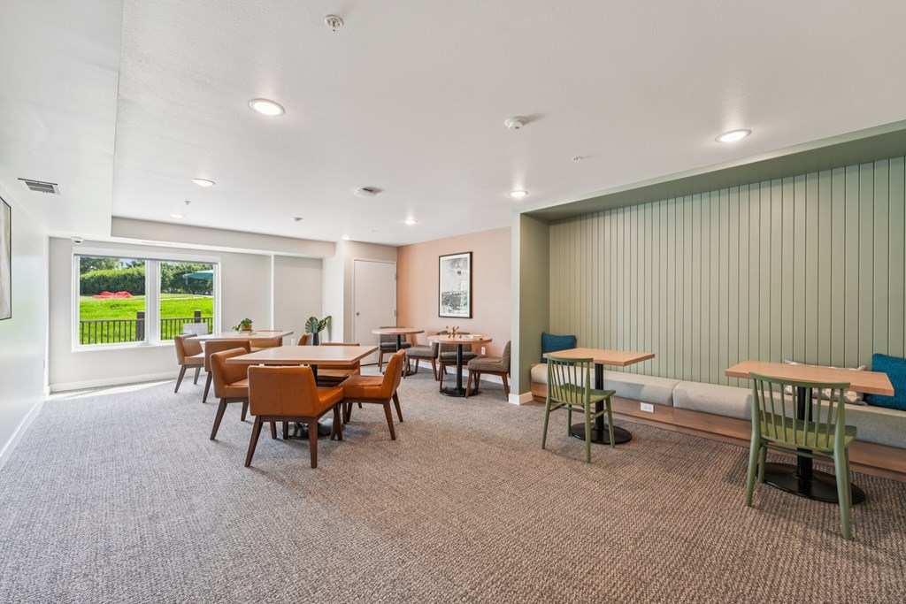 A room with a long table and chairs.