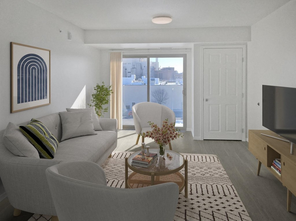 a living room with a couch and a chair and a television