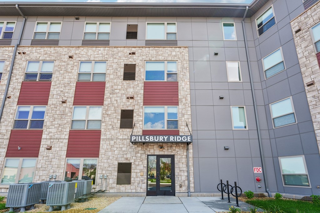 The Pillsbury Ridge building has a grey and red facade.