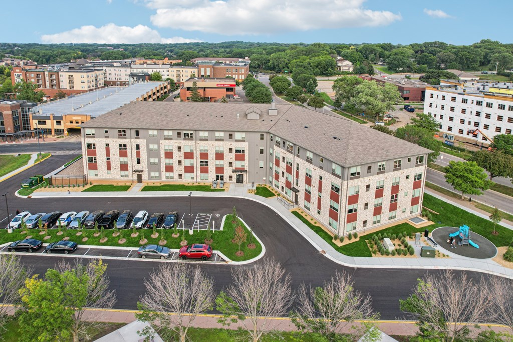 A large building with a parking lot in front of it.