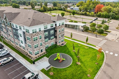 A large building with a playground in front.
