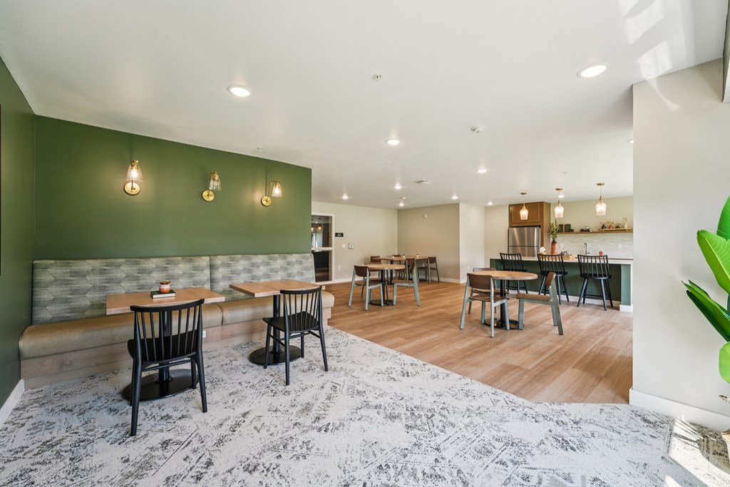 A room with a green wall and a grey carpet.
