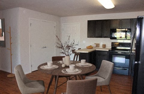 a kitchen and dining room with a table and chairs
