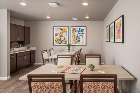 a dining room with a table and chairs and a kitchen