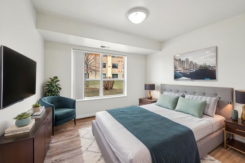 A bedroom with a large bed and a flat screen TV.