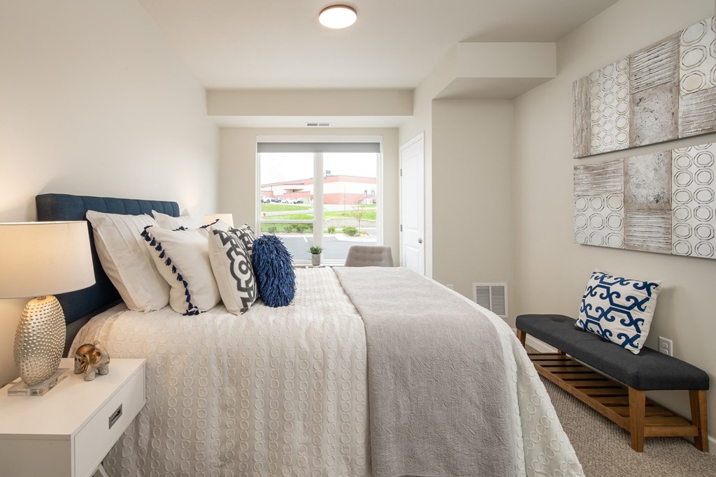 a bedroom with a large bed and a window
