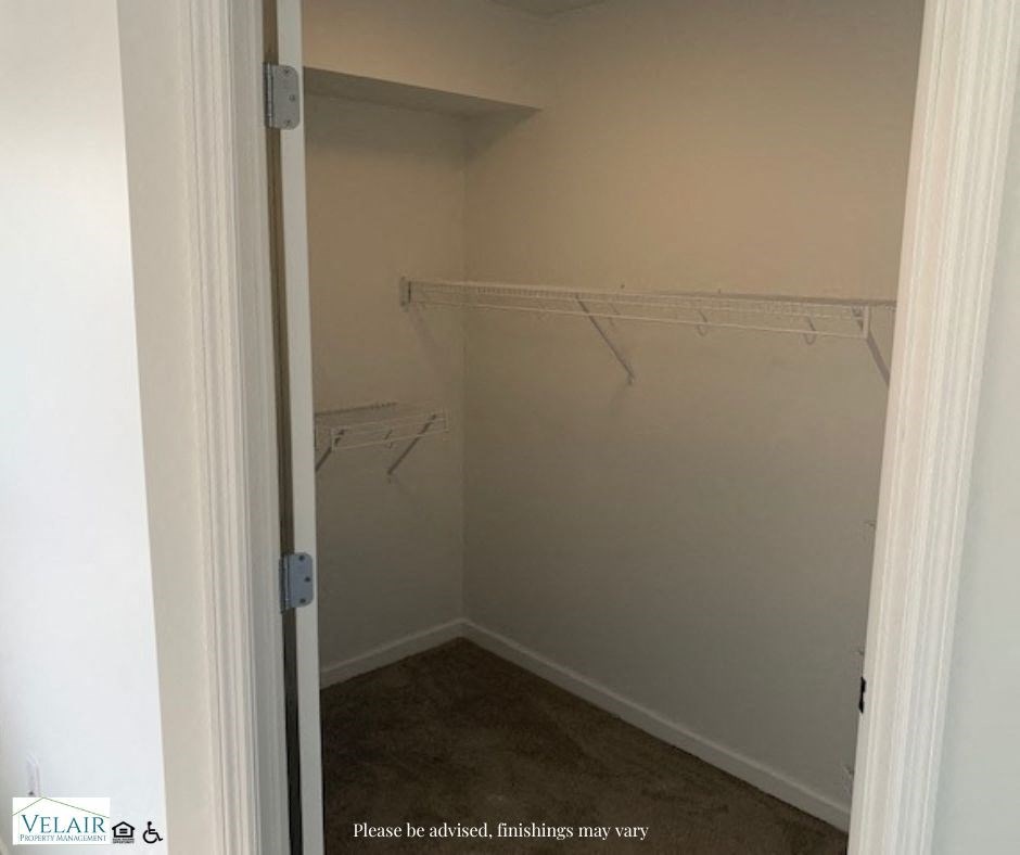 A white closet with a sign that says "Please he advised, finishes may vary".