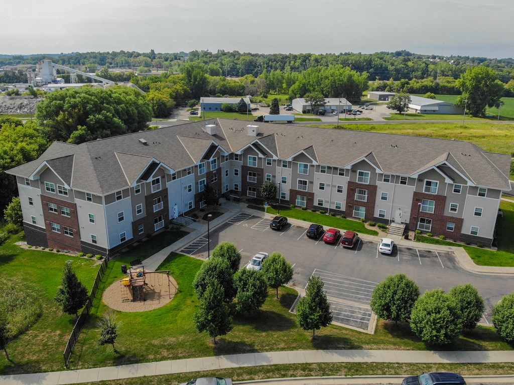 an aerial view of an apartment building in a parking lot