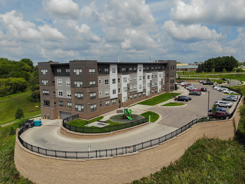 an aerial view of an apartment building with a parking lot