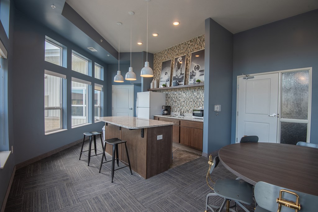 A kitchen with a bar area and a dining table.
