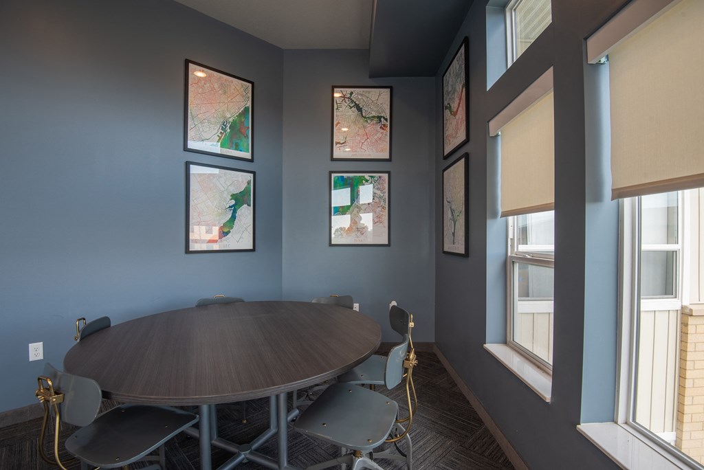 A round table with chairs is in the center of the room.