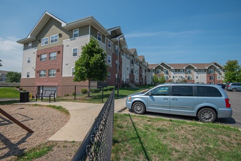 a van parked in front of an apartment building