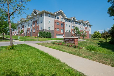 an apartment building with a sidewalk in front of it