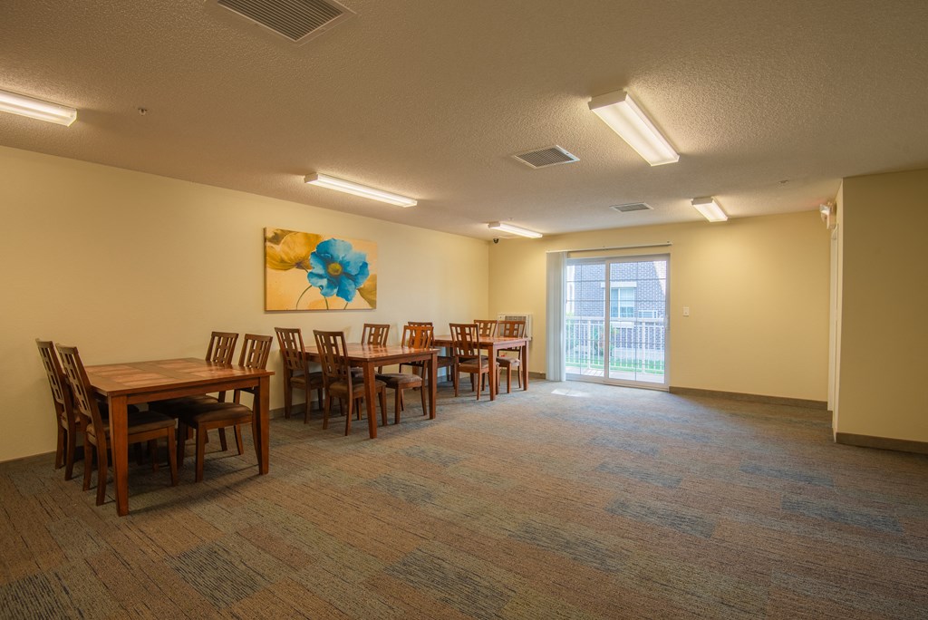 a dining room with tables and chairs and a sliding glass door