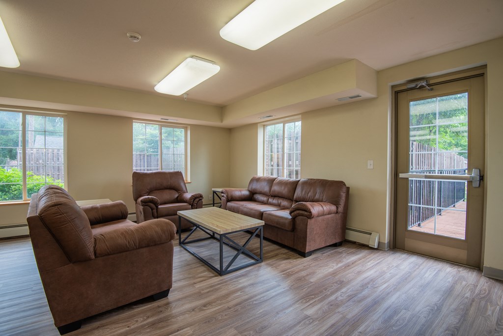 an empty living room with couches and a coffee table