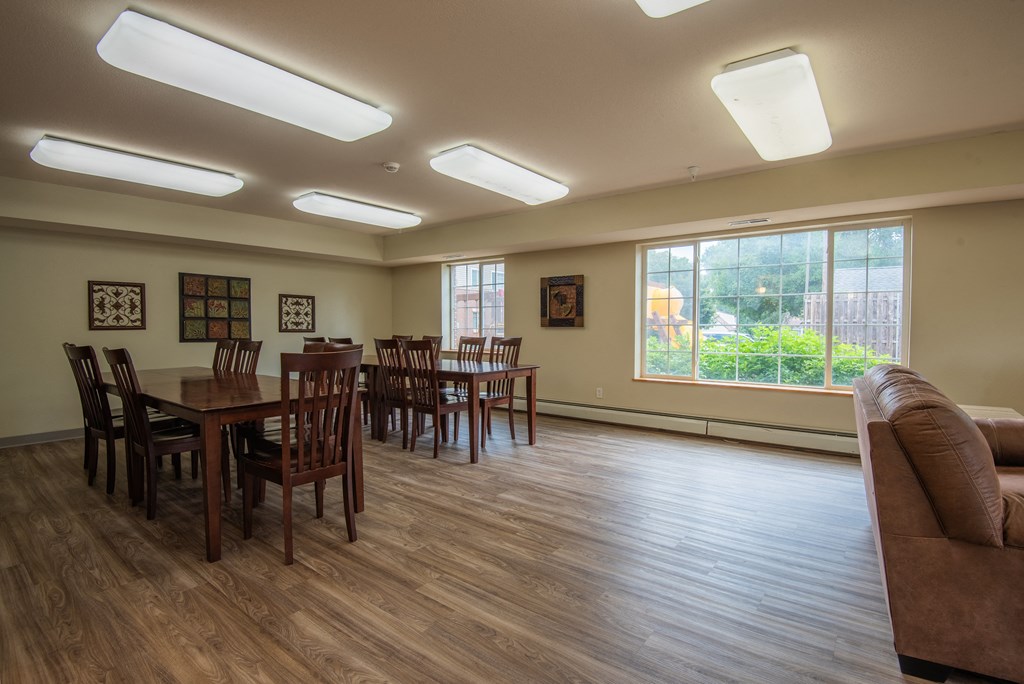 a common room with a table and chairs and a couch
