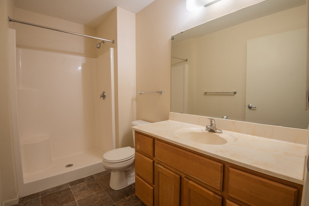 a bathroom with a sink toilet and shower