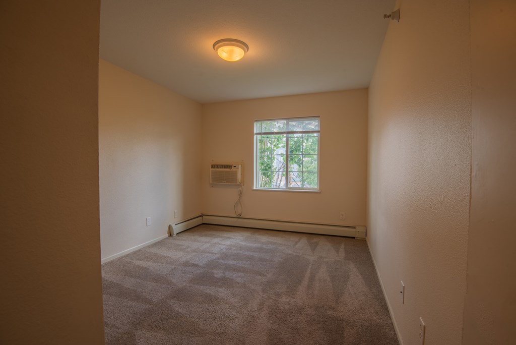 the living room of an empty house with a window