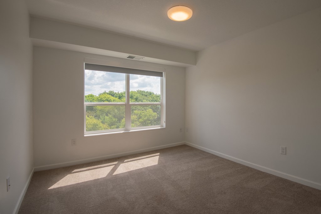 an empty living room with a large window