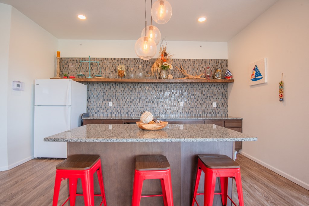 A kitchen with a white fridge and a counter with a bowl on it.
