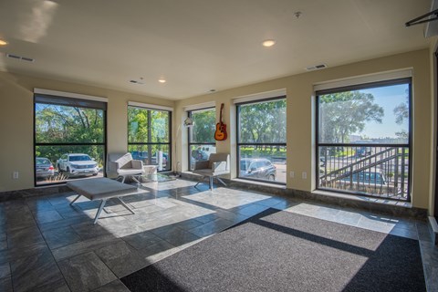 A sunny day in a spacious living room with a balcony.