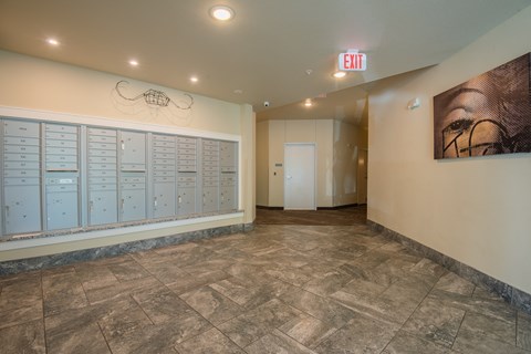 A hallway with a red exit sign above the door.