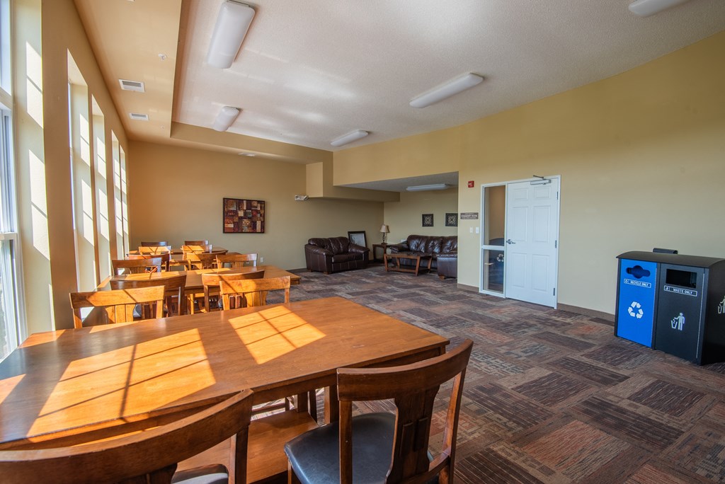 A conference room with a long table and chairs.