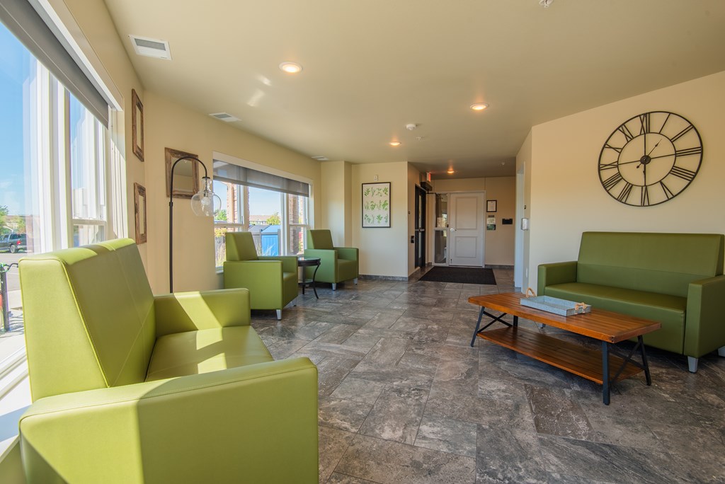 A living room with a large clock on the wall.
