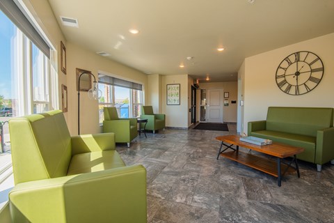 A living room with a large clock on the wall.